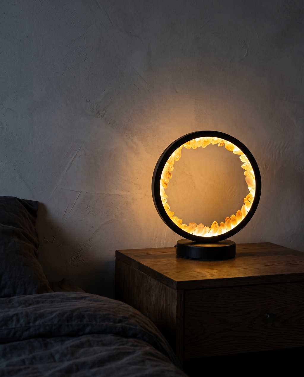Corona Lamp glowing amber on a bedside table in a dark bedroom