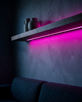 USB RGB strip lights glowing magenta under a floating shelf
