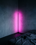 Corner Floor Lamp washing a bedroom corner in magenta