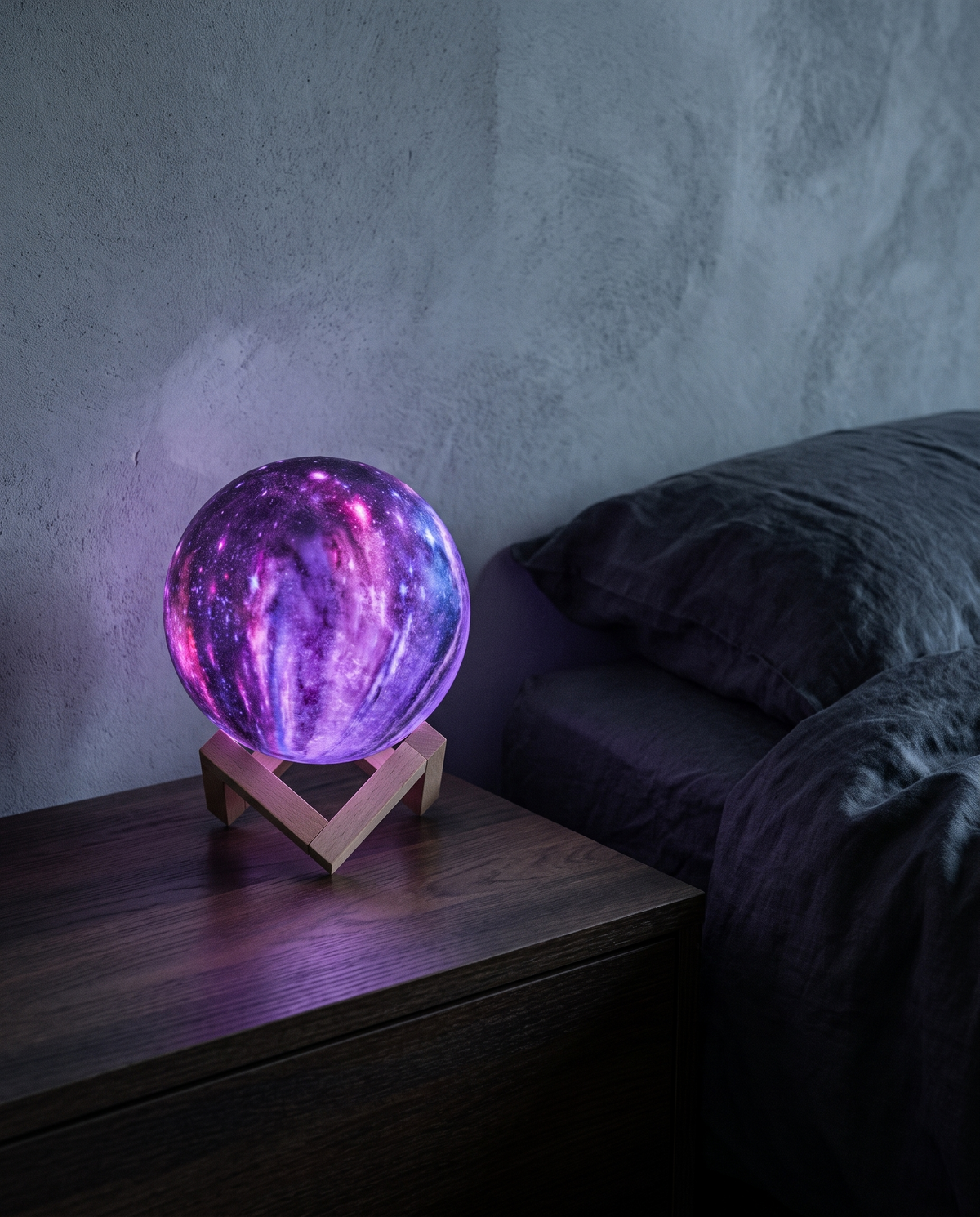 Galaxy Orb Lamp glowing violet on its wooden stand