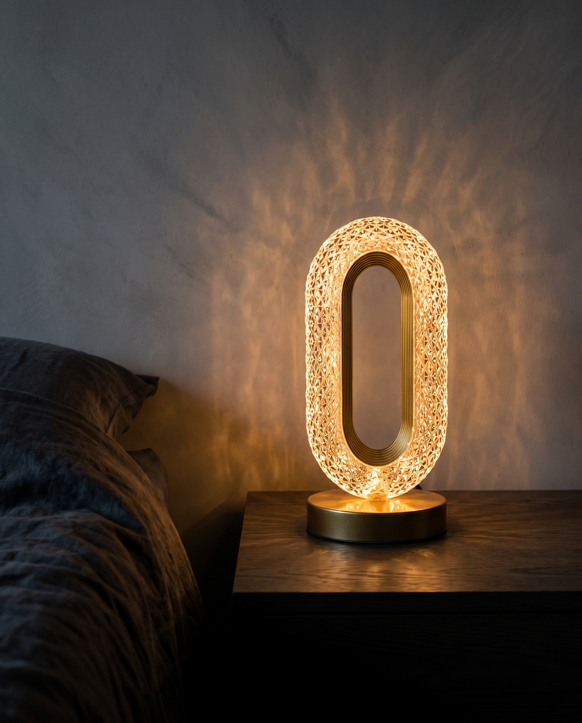 Prism Lamp scattering warm light on a bedside table