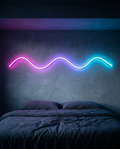 Neon Flex Strip glowing as a wave line above a bed