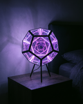 Infinity Dodecahedron glowing violet on a bedside table