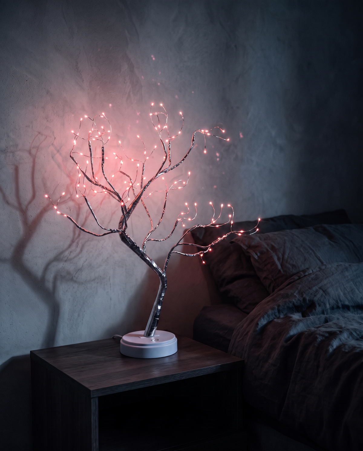 Tree Light with pink lights on a bedside table