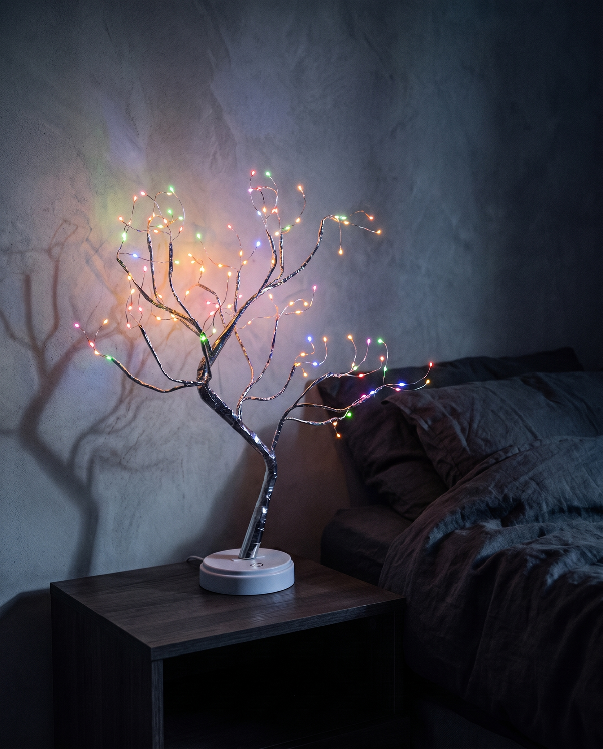 Tree Light with multicoloured lights on a bedside table